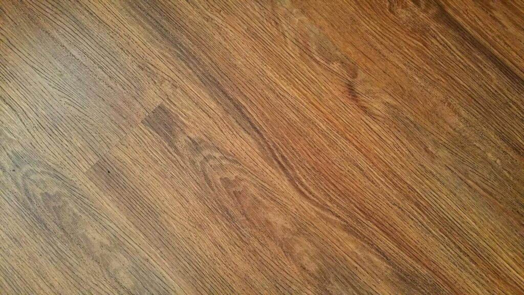 Detailed image of rustic wooden flooring with visible wood grain texture.